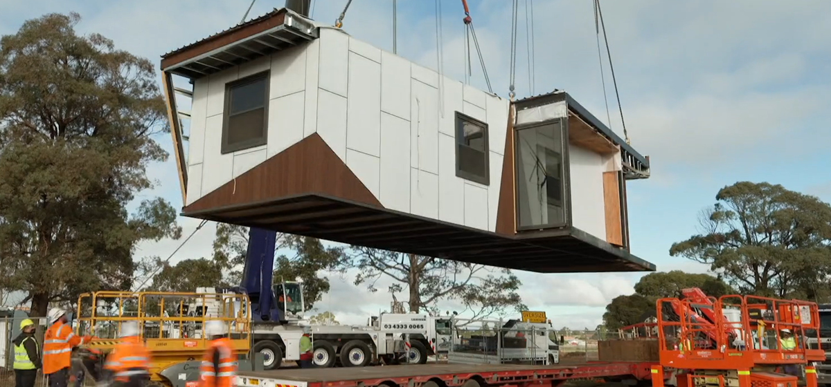 A section of the Corio rehabilitation facility being lifted in the air by a crane.