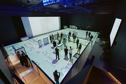 Hospital staff walking around a large scale floorplan of the Frankston Hospital redevelopment