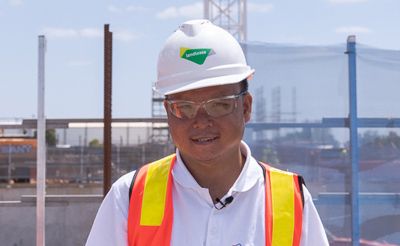 A man wearing a hard hat at a building site