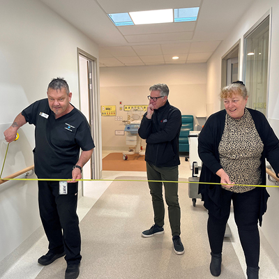Representatives measuring the corridor width in the prototype rooms.