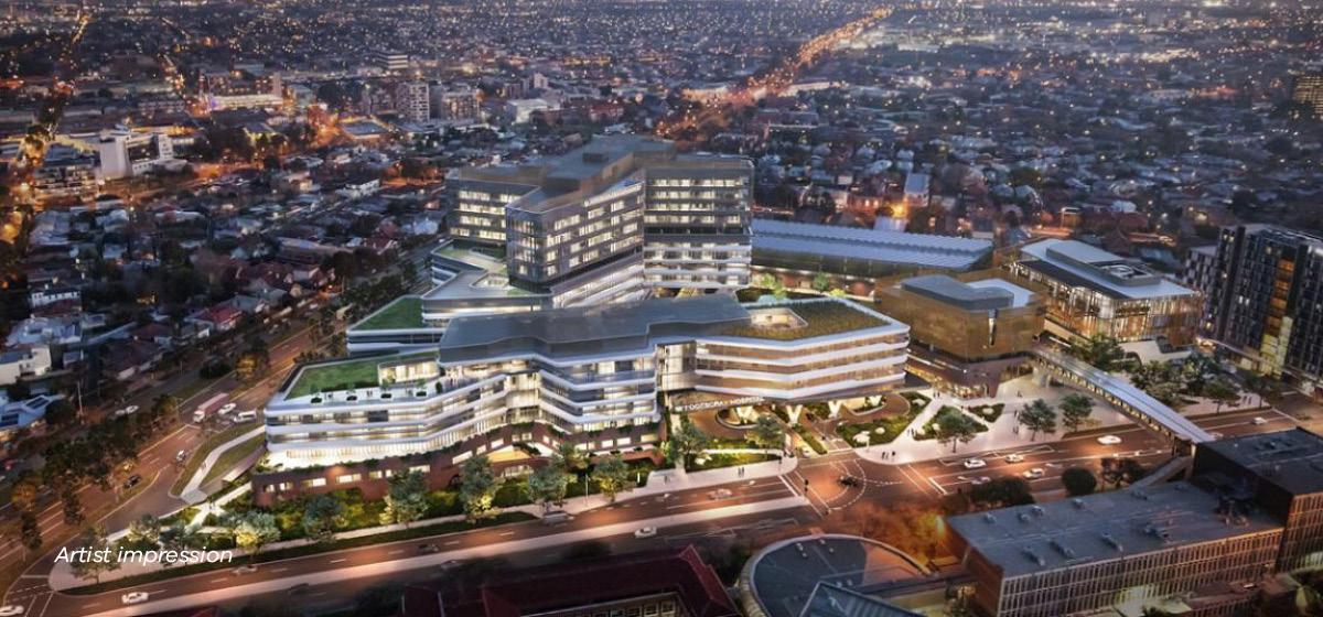 Artist impression of bird's eye view of hospital surrounding by glittering lights at night