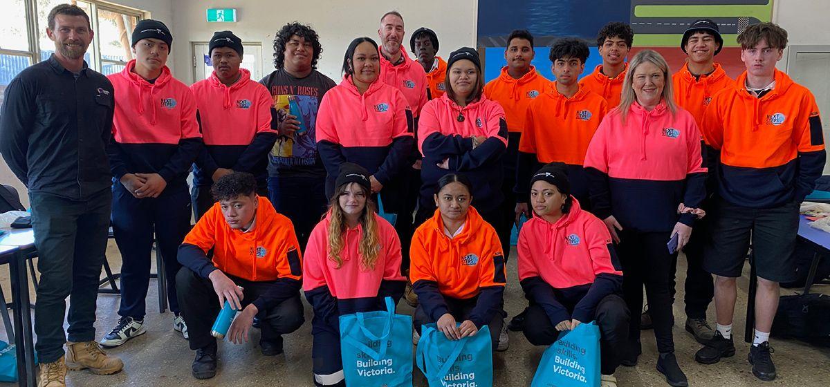 A group of students dressed in bright pink and orange jumpers