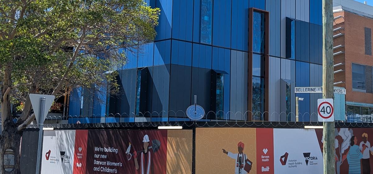 Construction site hoarding at Barwon Women's and Children's, with project artwork and the message 'We're building our new Barwon Women's and Children's'.