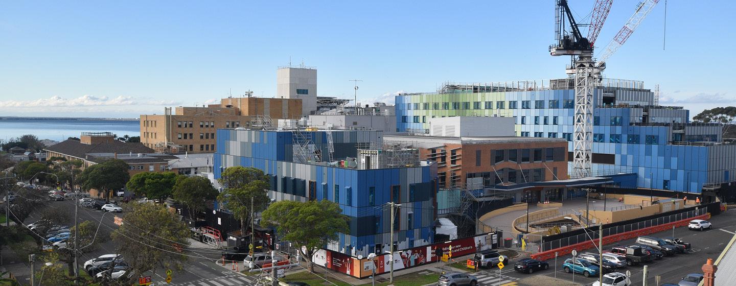 Aerial view of the Barwon Women's and Children's construction site, showing the building under construction with tower cranes and surrounding streets.