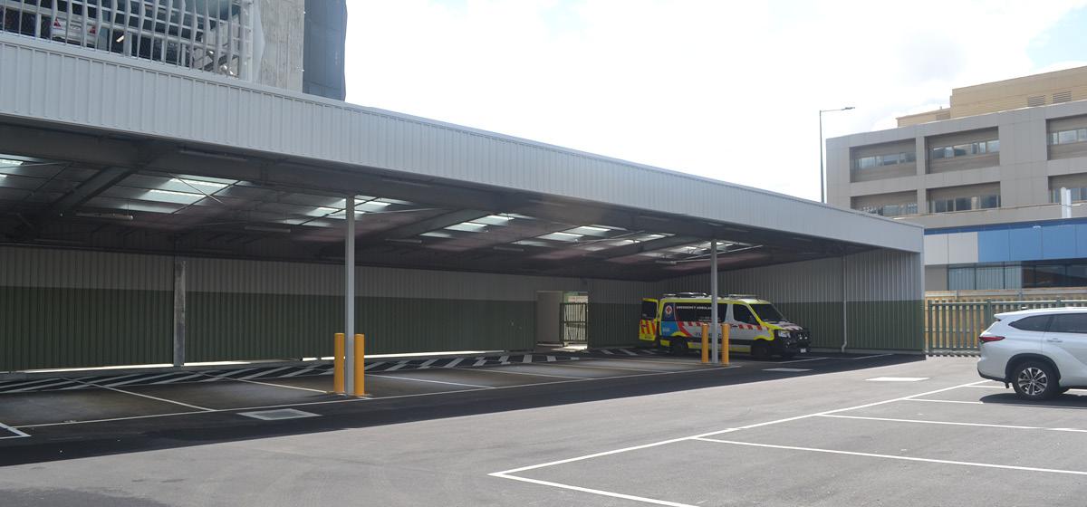 A carpark with one ambulance parked up the end
