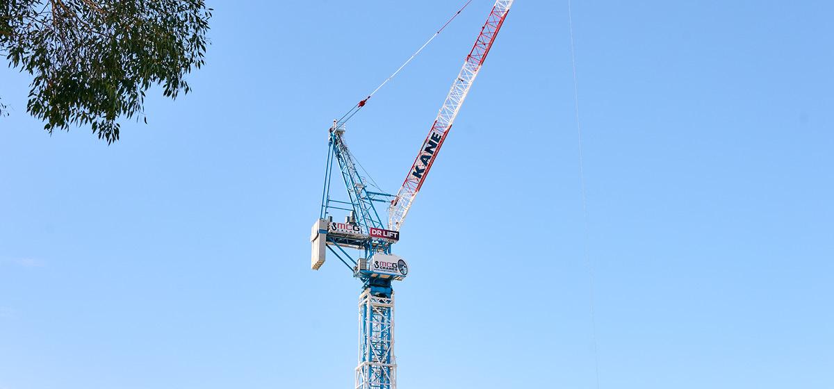 A crane against a blue sky with signage that says 'Dr Lift'