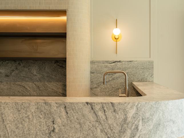 A marble-like countertop with a faucet