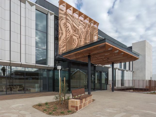 Main entrance to the Maryborough Hospital, with a large black and earth-coloured awning above the doors