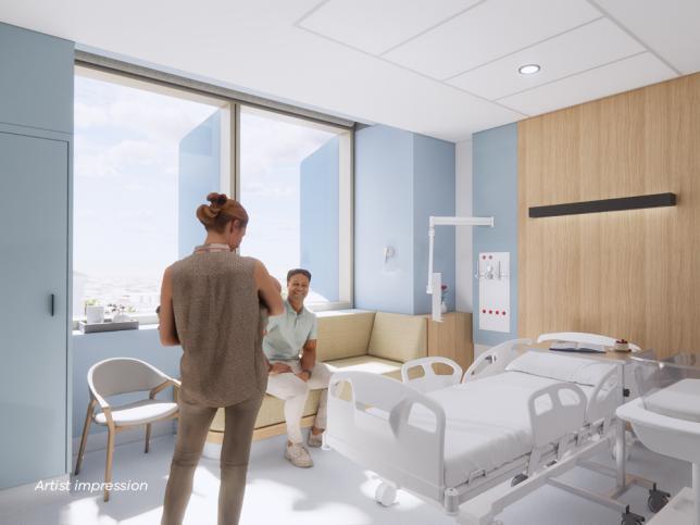 A woman holds a baby in a modern bright hospital room