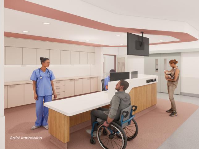 A health worker chats to a man in a wheelchair in a bright modern space