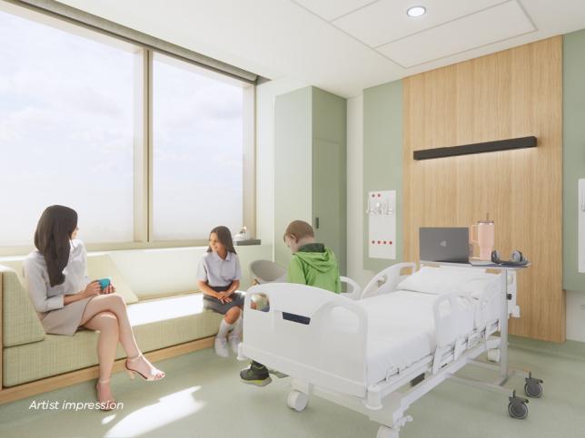 A woman and children sit in a well lit hospital room with calming tones