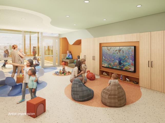 A bright fun looking space with circles and soft seating on the ground