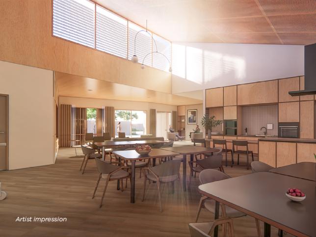Artist impression of a sunlit kitchen with dining tables and chairs