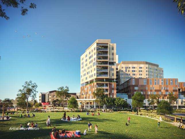 Artist impression of a park in front of multi-story hospital building on a sunny day, with people enjoying picnics and activities on the grass.