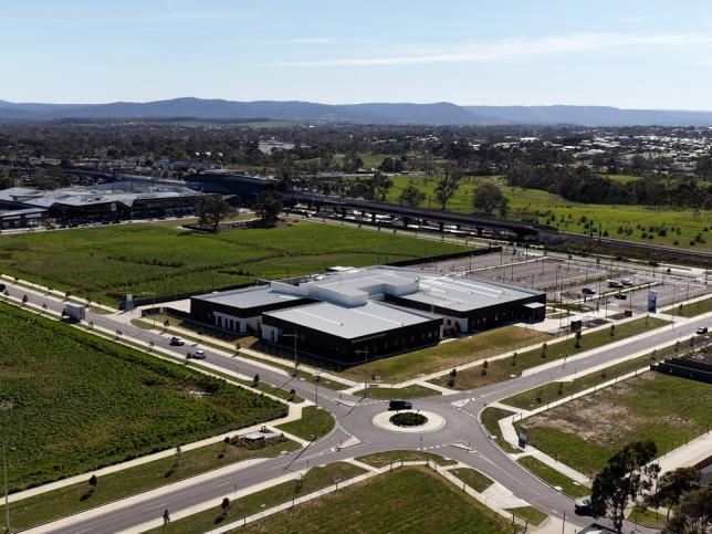 aerial image of completed building surrounded by green fields