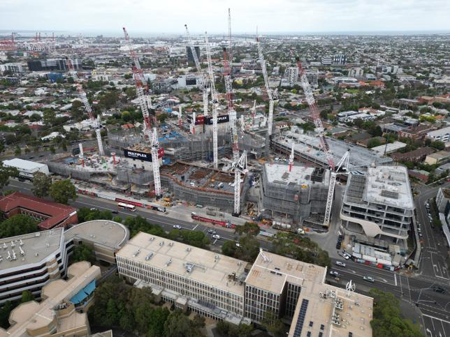 A construction site with many tower cranes