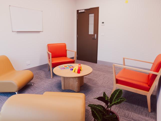 A room with four armchairs and a coffee table