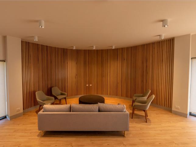 A warm-toned interior with couch and chairs