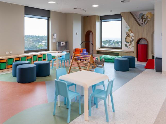 Children's play area with kid-sized table and chairs and colourful drawers
