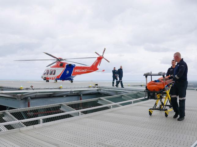 A helicopter hovers above a rooftop