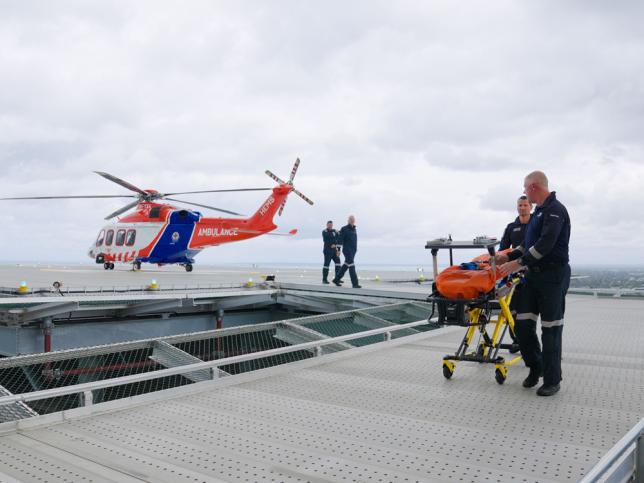 A helicopter hovers above a rooftop