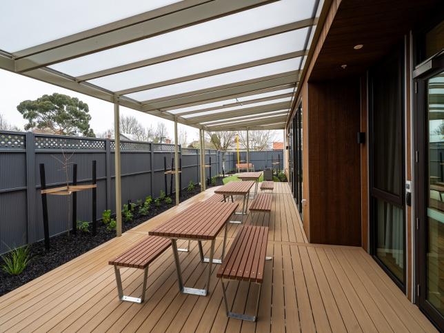An outdoor area with a row of picnic tables