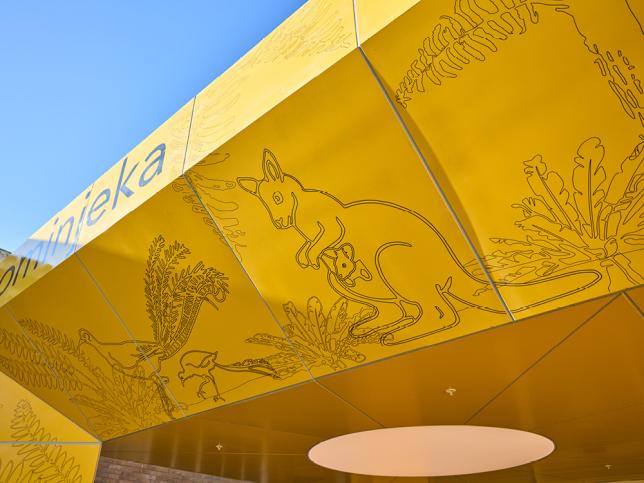 Yellow entrance canopy featuring illustrated native plants and animals, including a kangaroo with joey.
