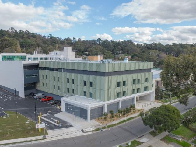 Aerial view of the new Angliss Hospital building, showing the multi-storey exterior, car park and surrounding trees and streets.