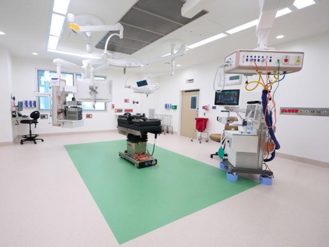 Operating theatre at the new Angliss Hospital building, fitted with overhead surgical lights, medical monitors and an operating table.