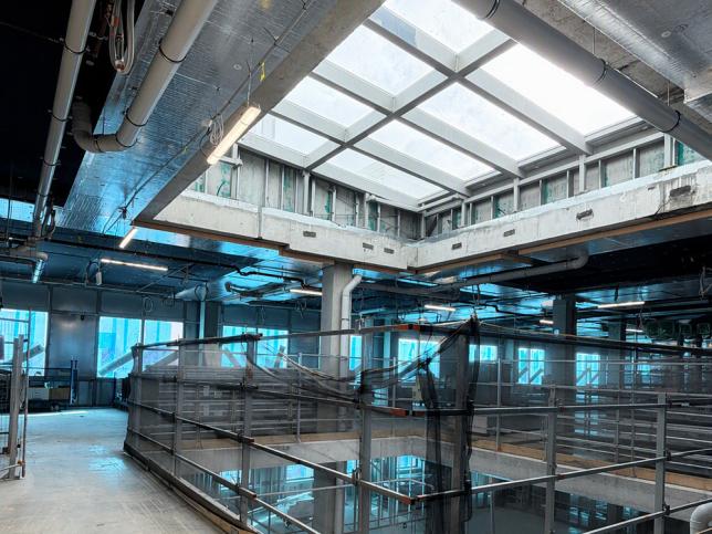 Construction photo inside the Barwon Women's and Children's building, showing an open atrium with a glass roof and safety netting.