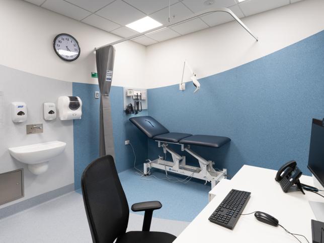 A consulting room with blue and white walls