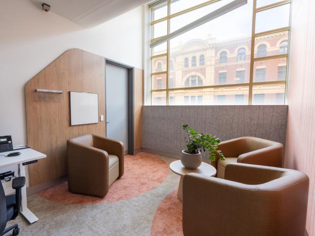 A counselling room with three brown chairs