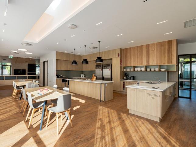 A light-filled kitchen area with dining tables