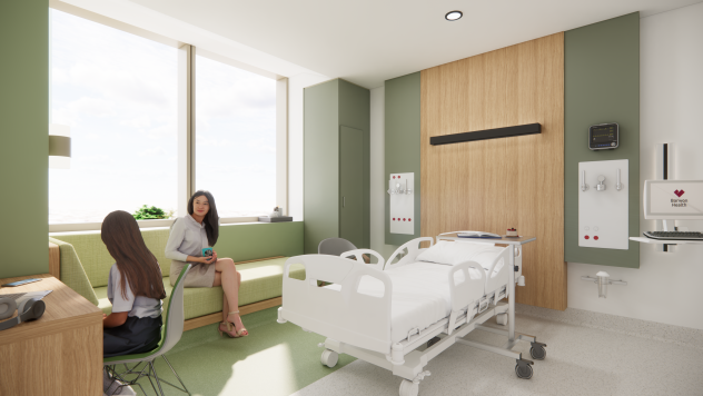 A woman and teenager sit in a hospital room with a calming green and wood tone interior