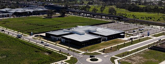 Aerial view of completed building surrounded by green fields