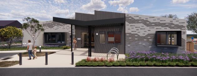 An artist's impression of a modern, single-story building with a mix of gray and brick-patterned walls. It features a black canopy over the entrance and decorative plants in front. Some individuals are near the entrance, and a bicycle rack is visible.