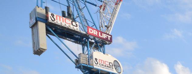 A crane against a blue sky with signage that says 'Dr Lift'
