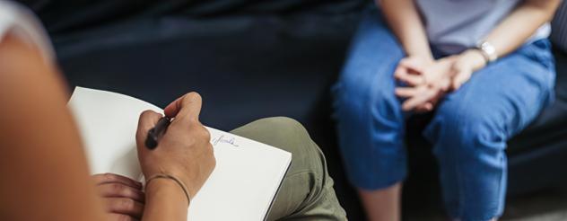 A professional taking notes during a consultation